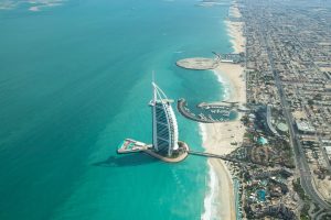 Aerial view of Dubai city beach and coast line on a clear sunny day.